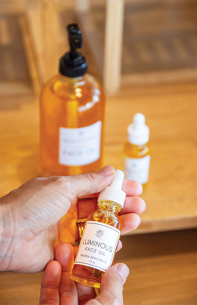 a hand holding a small bottle of liquid