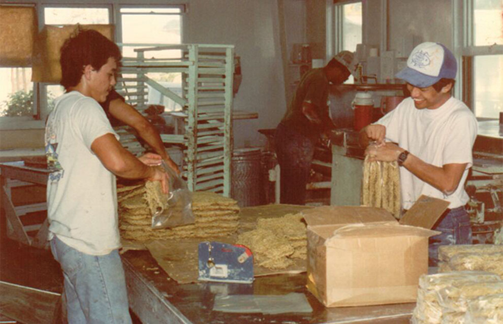 old photograph of two people tending in the kitchen