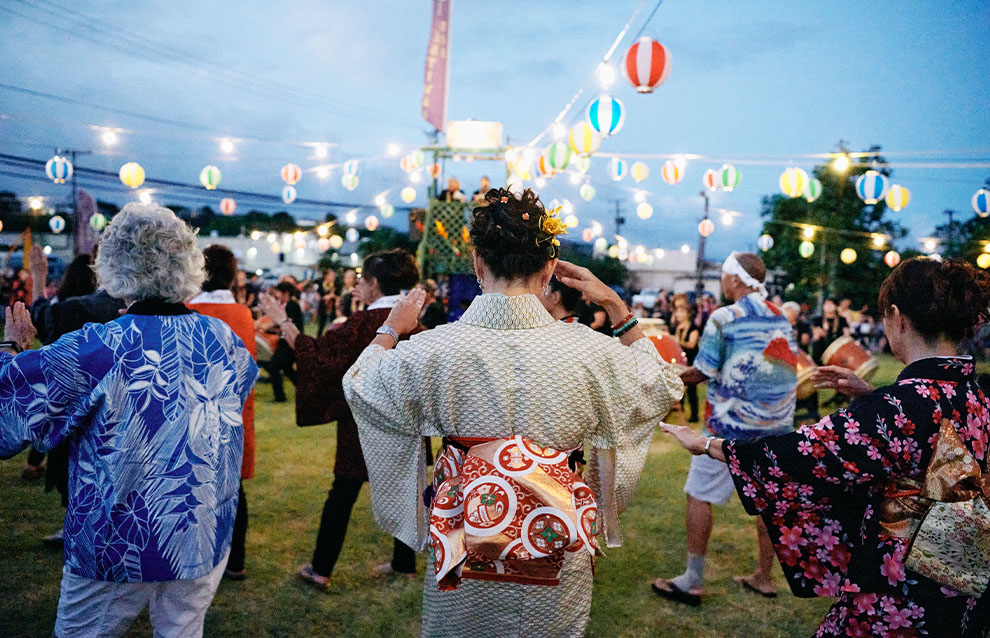 a festival with lots of people wearing traditional Japanese clothing (kimono)