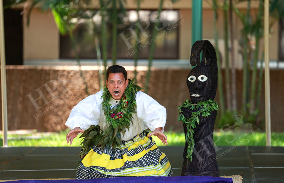 a person performing next to a sculpture