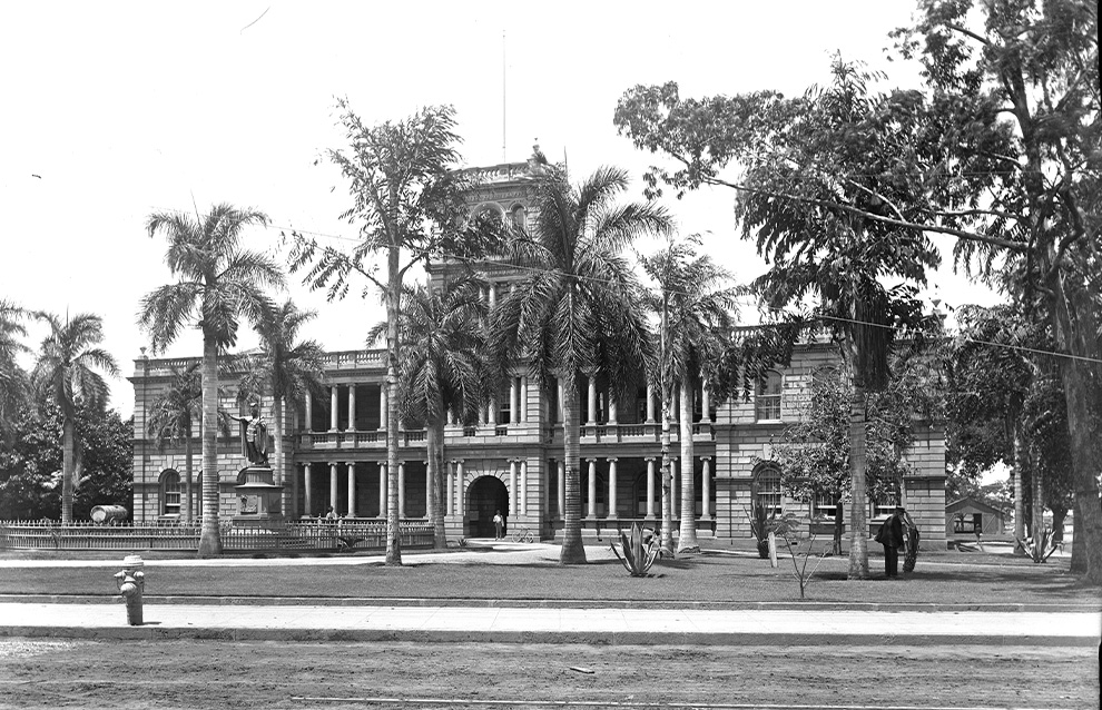 an old photograph of an old estate with palm trees surrounding it
