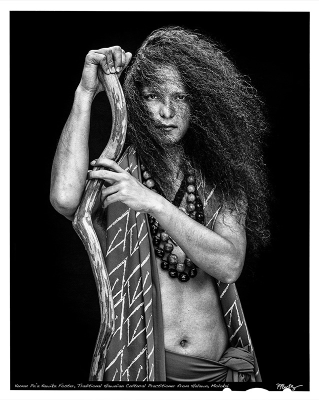 a person with long hair holding a stick