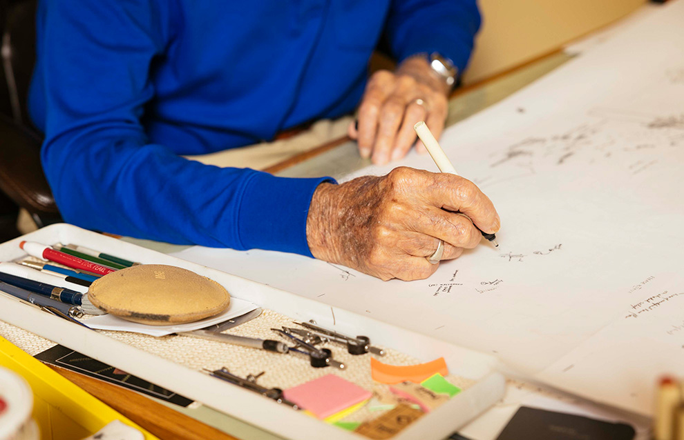 a person writing on a piece of paper