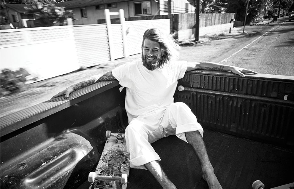 a person sitting in the back of a truck with a skateboard