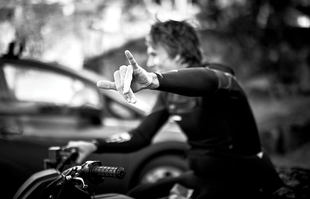 a person on a motorcycle making a hand gesture