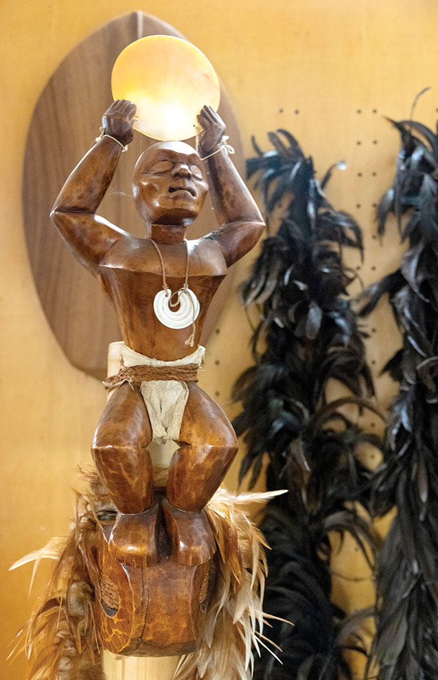 a statue of a person holding a light