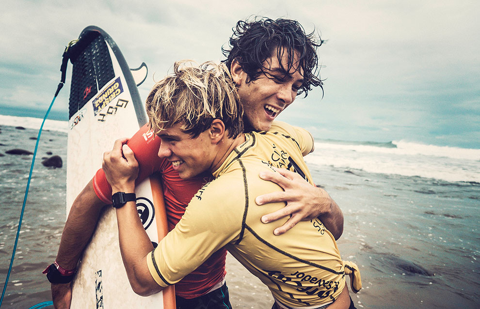 two men hugging on the beach