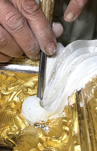 a person's hand holding a tool
