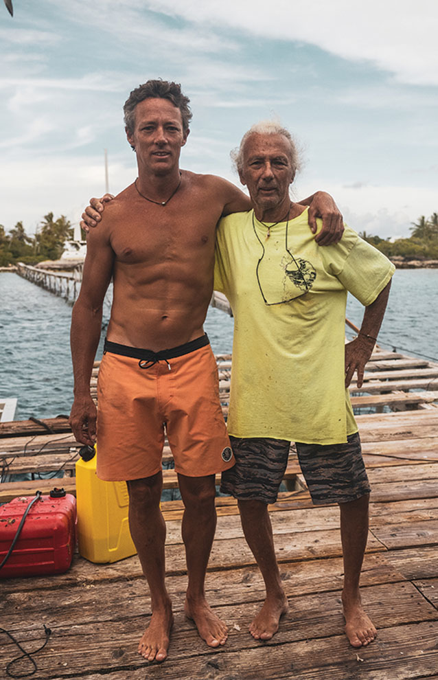 two men standing on a dock