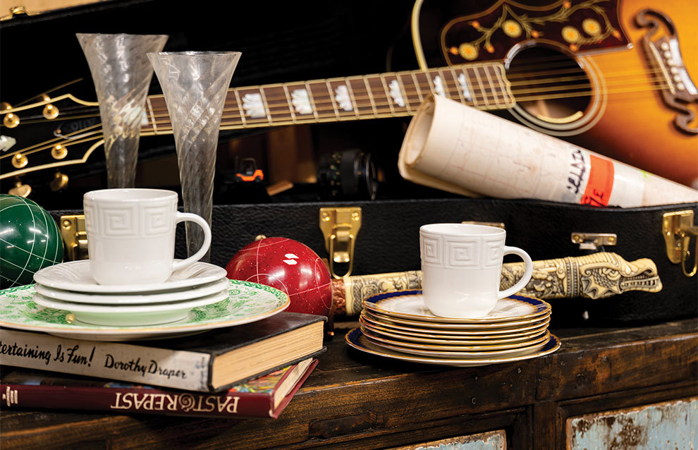 a stack of plates and cups on a table
