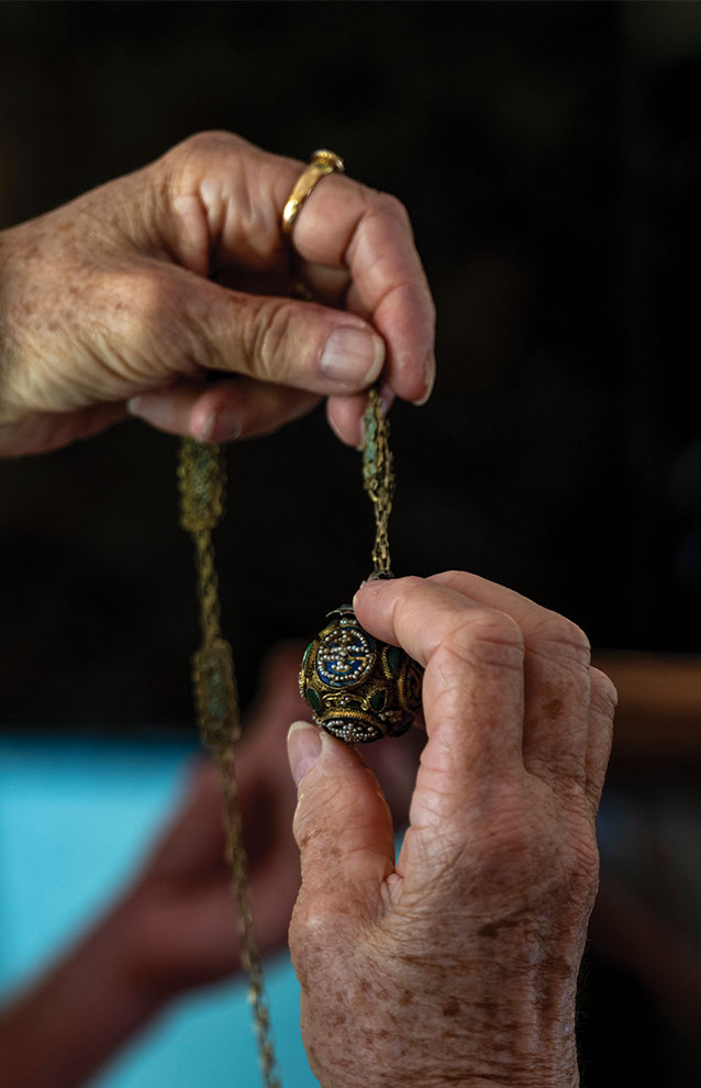 a person holding a necklace