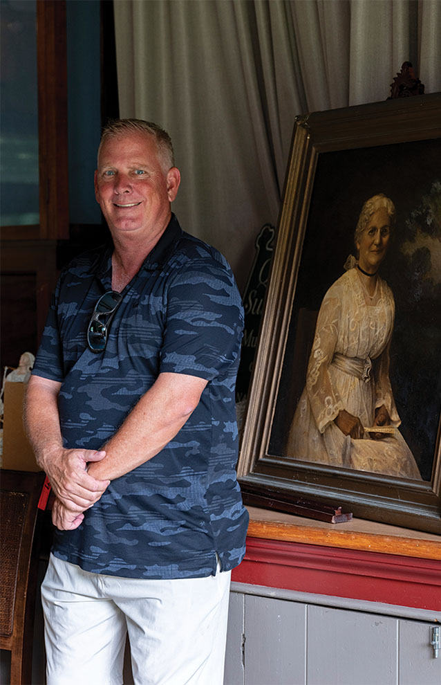 a person standing next to a painting