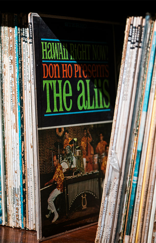 a closeup of a shelf with record sleeves