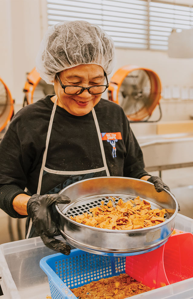 person wearing a hair net working in the kitchen