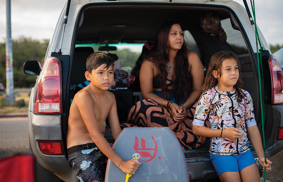 a group of people sitting at the back of a car