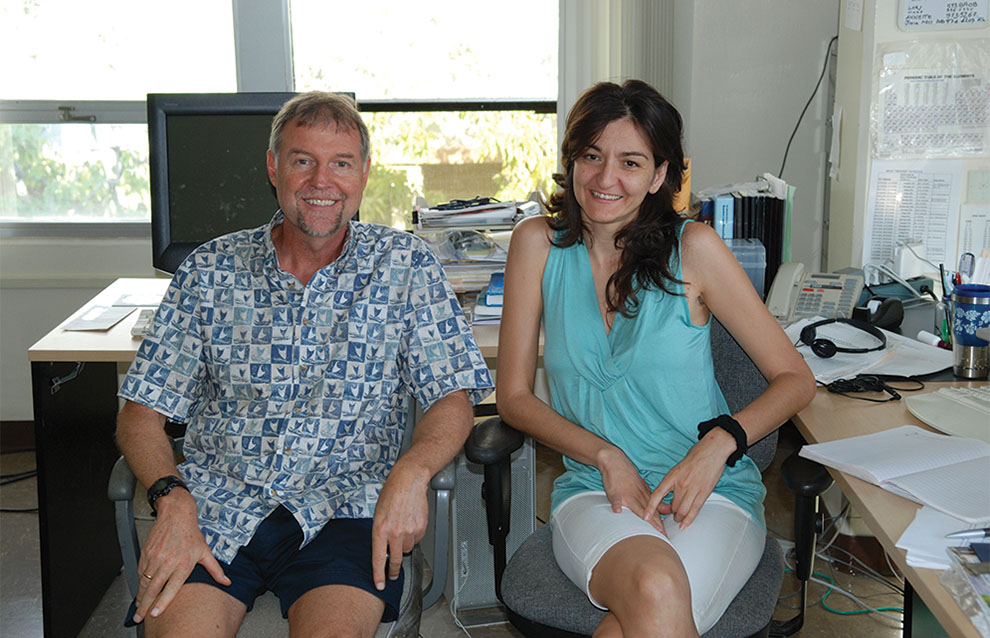 two people sitting side by side inside an office
