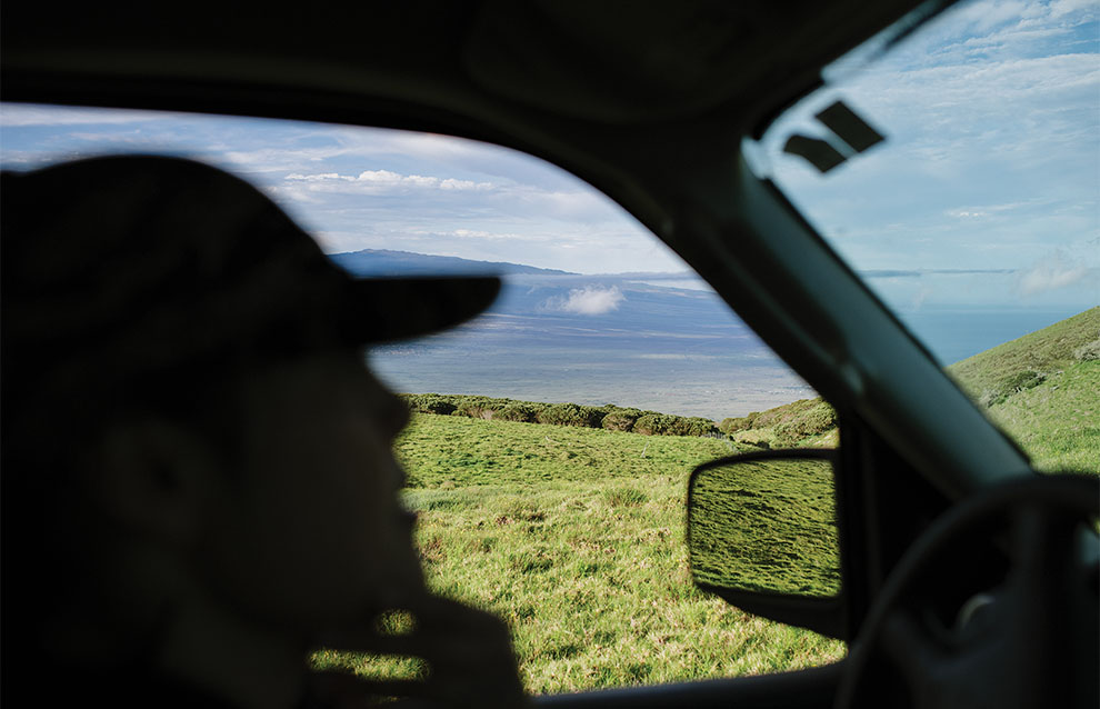 a person driving around grassy lands