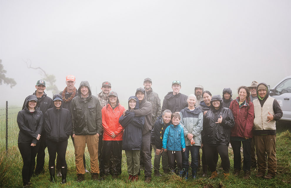a large group of people stand together for a photo