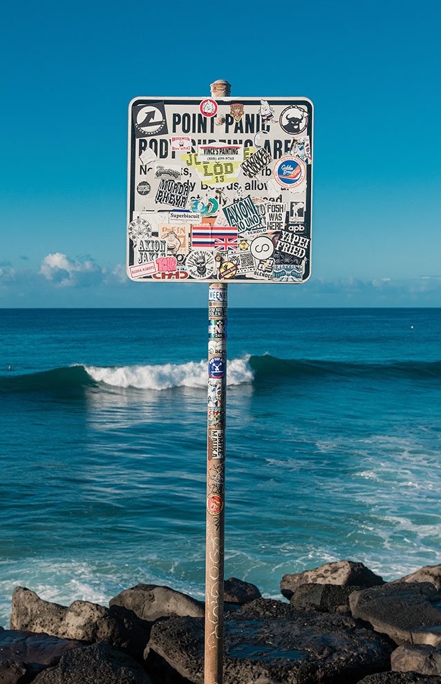 a photo of a sign with the ocean at the back
