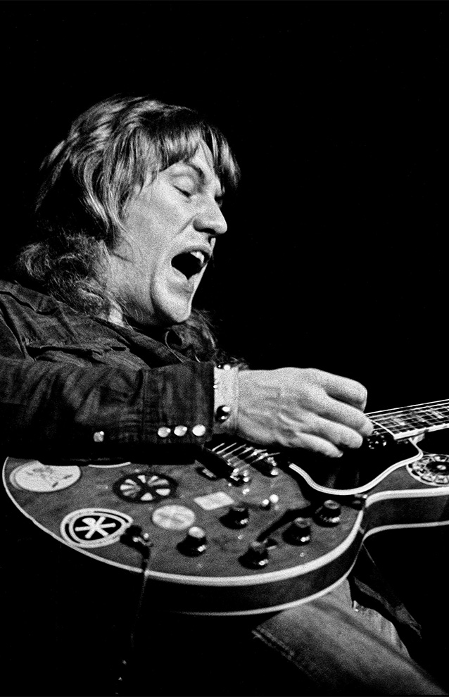 closeup of a person playing an electric guitar