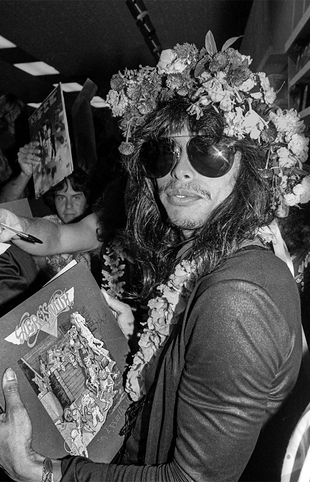 person holding a record, wearing sunglasses and a record sleeve