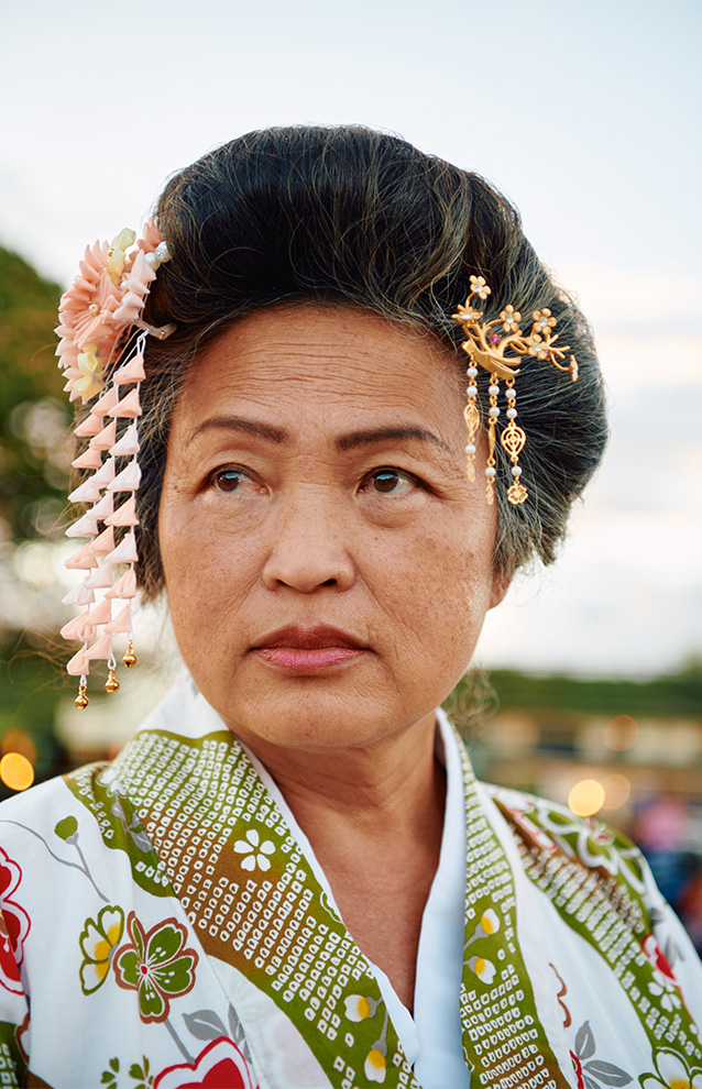 portrait of a person wearing traditional Japanese clothes with accessorized hair