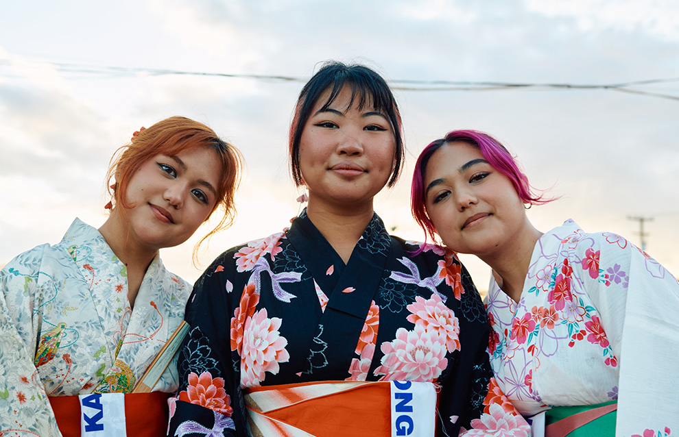 three people take a photo wearing traditional Japanese clothing