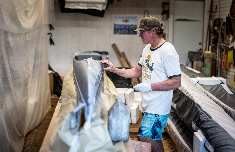 a person inside a studio tending to a kayak